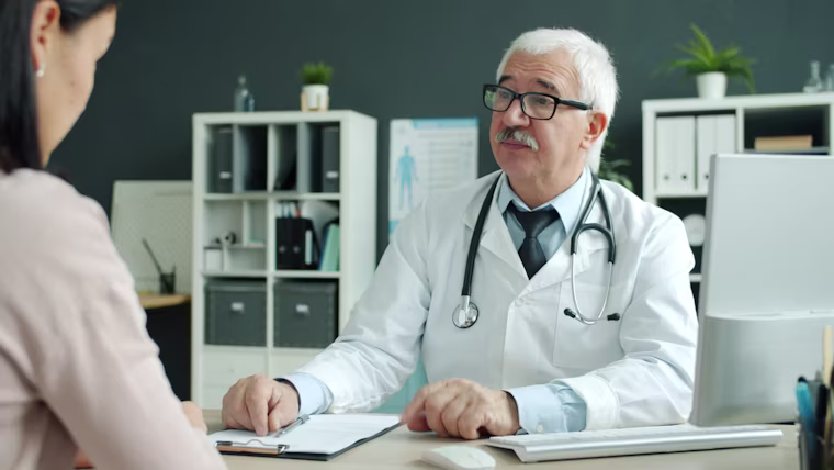 Physician meeting with a patient in a private practice office